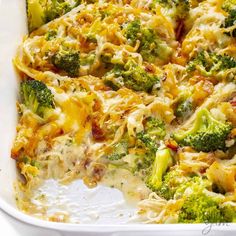 a casserole dish with broccoli, cheese and other toppings in it