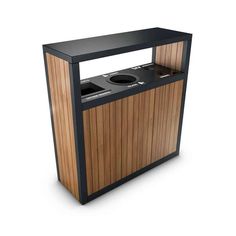 a black and wood counter with two speakers on it's sides, in front of a white background