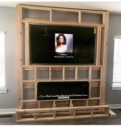 a flat screen tv mounted to a wooden wall