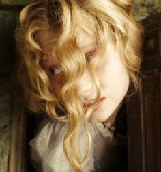 a close up of a child with blonde hair