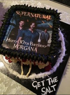 a birthday cake with the words supernatural on it