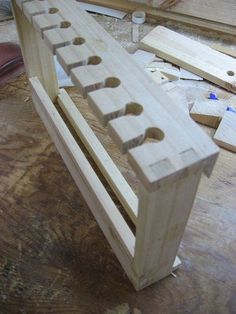 a wooden bench made out of wood with holes in the top and bottom part missing