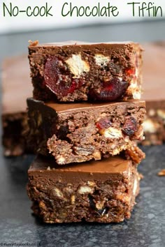 three brownies stacked on top of each other with cherries and nuts in them