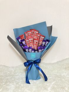 a bouquet of chocolates wrapped in blue paper