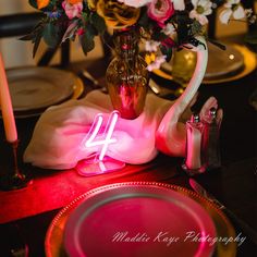 the table is set with flowers and candles