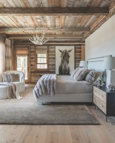 a bedroom with wood paneling and a horse head on the wall above the bed