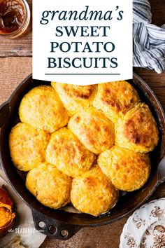 a pan filled with sweet potato biscuits on top of a wooden table