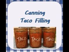 three jars filled with taco filling sitting on top of a blue and white checkered table