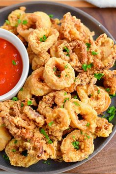 fried food on a plate with dipping sauce