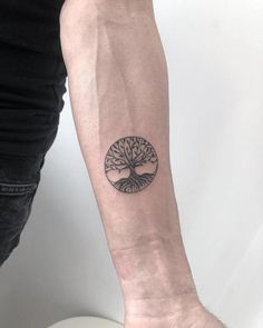 a person with a tree tattoo on their arm