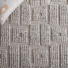 a close up view of a gray rug