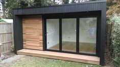 a small wooden building with sliding glass doors