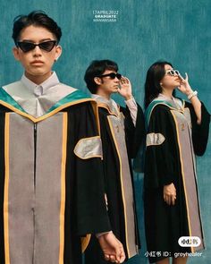 two people in graduation gowns standing next to each other with sunglasses on their heads