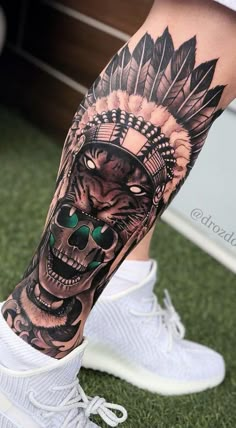 a man's leg with a tattoo on it and a skull in the middle