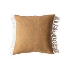 a brown pillow with white fringes on it