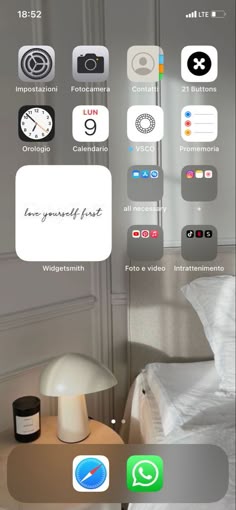 an iphone with the home screen showing icons for different rooms and furniture, including a bed