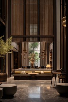 a living room filled with lots of furniture and tall windows covered in shades of brown