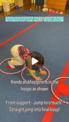 a child is playing with a hula hoop on the floor and has an instruction video about how to do it