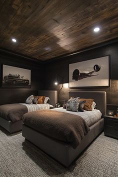 two beds in a room with wooden ceiling and carpeted flooring, along with pictures on the wall