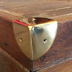 a close up of a wooden box with a metal door handle on the top and bottom