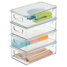 three drawers with plastic dividers on each side and various office supplies in the bottom drawer