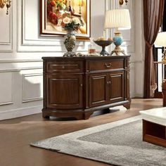 a living room filled with furniture next to a painting on the wall above a coffee table