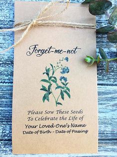 forget me not seed packet with blue flowers on it and string tied to the front