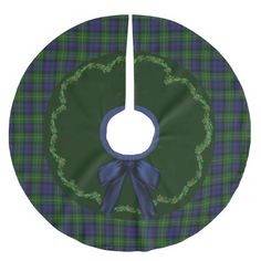 a green and blue tartan plaid christmas tree skirt with a bow on the front