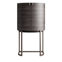 a round table with a metal base and a black drum on it's side