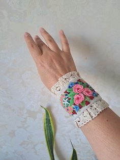 Linen detachable cuff bracelet with Embroidery are an extraordinary accessory that adds elegance to your casual clothes and turn them into haute looks and burst into your linen paradise. This beautiful unique Design linen fabric bracelet is made with embroidered  pink flowers with finishing lace and beads . Button closure. This cuff can be worn like real bracelet. The whole composition has a Boho Chic Style- elegant air and can be the piece of resistance for any outfit. You can wear them like on Handmade Cuff Bracelets For Weddings, Bohemian Cuff Bracelet For Spring, Spring Bohemian Cuff Bracelet As Gift, Spring Bohemian Cuff Bracelet For Gift, Spring Bohemian Cuff Bracelet, Handmade Bracelets For Spring Festival, Bohemian Embroidered Bracelets For Weddings, Bohemian Cuff Bracelets For Spring, Spring Gift Wristlet With Wrist Strap