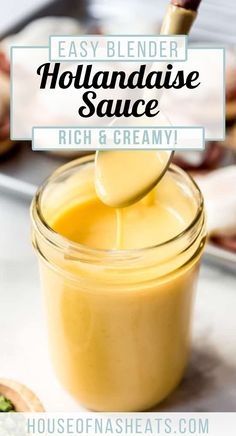 homemade hollandaise sauce in a glass jar with a spoon sticking out of it