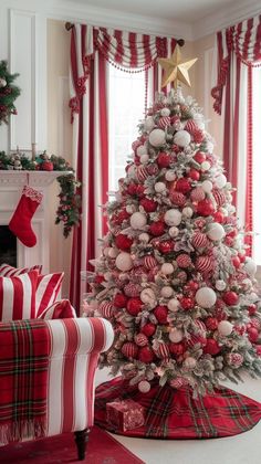 a decorated christmas tree in a living room with red and white ornaments on the top