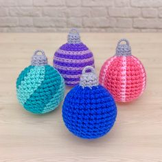 three crocheted ornaments sitting on top of a wooden table