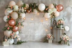 the backdrop is decorated with balloons and flowers