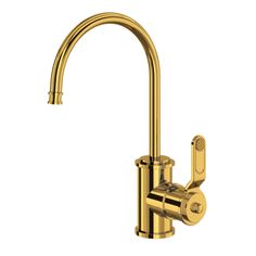 a brass colored faucet with red knobs on the side and a white background