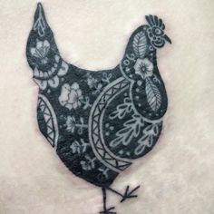 a black and white hen tattoo on the stomach