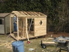 a man standing next to a shed in the yard