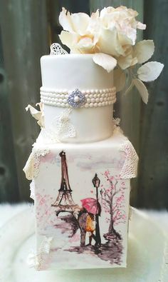 a wedding cake decorated with an image of the eiffel tower