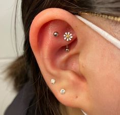 a woman with three piercings on her ear