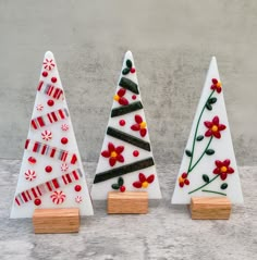 three ceramic christmas trees with candy canes on them