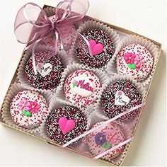 a box filled with lots of decorated donuts