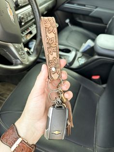 This tooled leather keychain is the perfect western accessory to keep track of your keys & make a statement, all at the same time. This keychain is handcrafted from scratch & tooled with care. It is finished with a silver rivet & stainless steel keyring. Due to the handmade nature of this item, the actual product may vary from the photo. All keychains are made to order, so they will be unique. Western Key Chain, Cute Western Car Accessories, Western Christmas Gifts, Car Keychain Aesthetic, Cute Keychains For Car Keys, Tooled Leather Keychain, Truck Interior Accessories, Western Car, Custom Leather Work