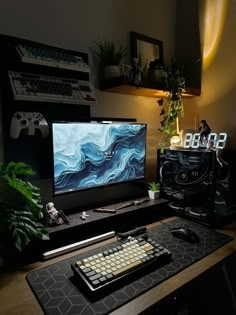 a desk with a keyboard, mouse and monitor on it in front of a plant