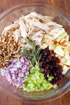 the ingredients for this salad are mixed together in a glass bowl on top of a wooden table