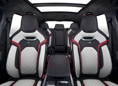 the interior of a car with red and white stitching on it's seats