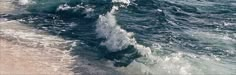 a man riding a surfboard on top of a wave in the ocean next to a sandy beach