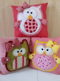 three pillows with owls on them sitting next to each other