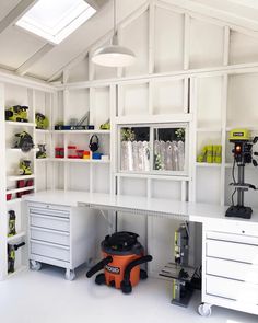 a workbench with lots of tools and supplies on the shelves in front of it