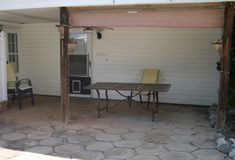 a table and chairs sitting under an awning