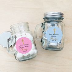 two glass jars filled with white and pink candy